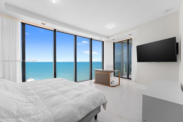 bedroom with access to exterior and expansive windows