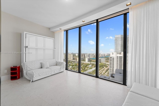 living room featuring expansive windows and a healthy amount of sunlight