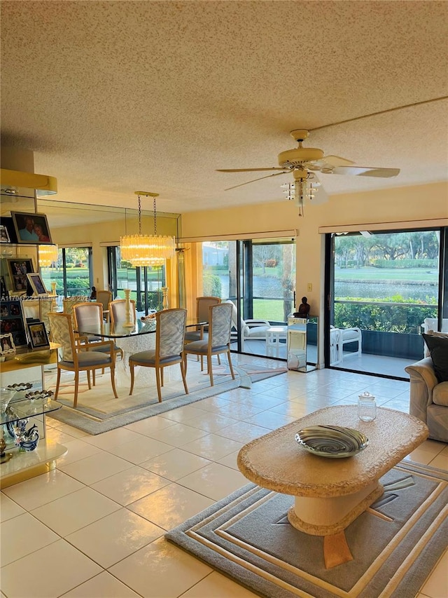 tiled living room featuring ceiling fan, a healthy amount of sunlight, and a textured ceiling