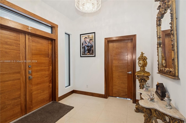 7001 Robles St, Coral Gables, FL 33143 - entrance foyer featuring baseboards and a chandelier