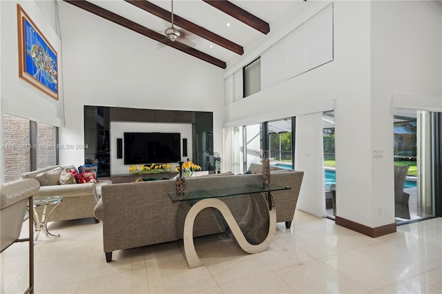 living room featuring ceiling fan, beamed ceiling, high vaulted ceiling, and light tile patterned flooring