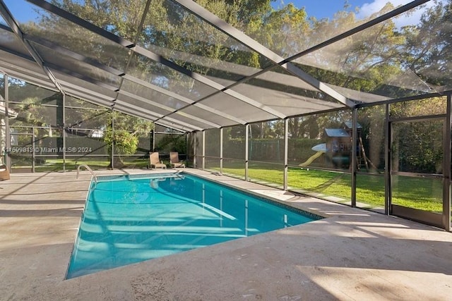 view of pool with a lanai, a yard, and a patio