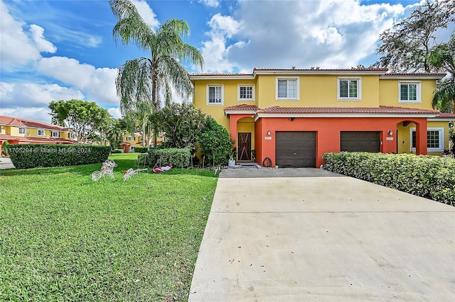 mediterranean / spanish-style home featuring a garage and a front yard