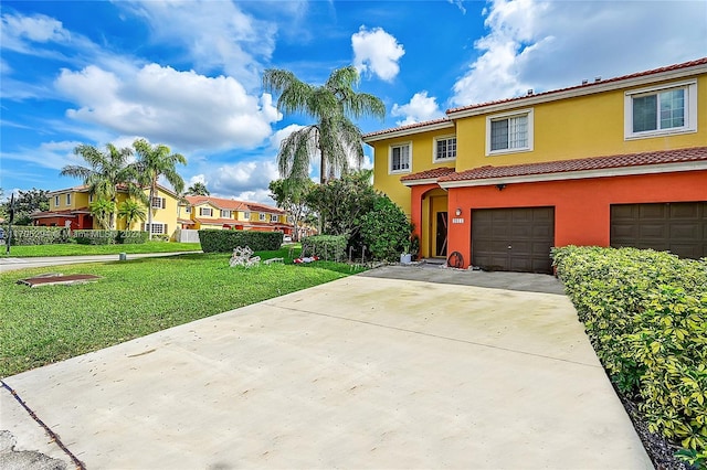 mediterranean / spanish-style home with a garage and a front lawn