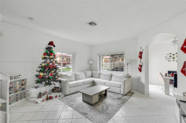 2011 SW 103rd Ter, Miramar, FL 33025 - living area featuring arched walkways, a textured ceiling, light tile patterned floors, and ceiling fan