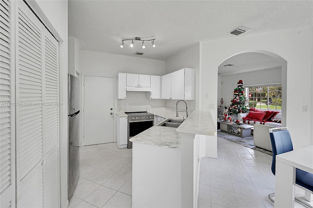 2011 SW 103rd Ter, Miramar, FL 33025 - kitchen with appliances with stainless steel finishes, a peninsula, under cabinet range hood, white cabinets, and light tile patterned flooring