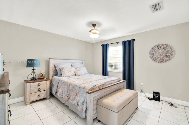 tiled bedroom with ceiling fan