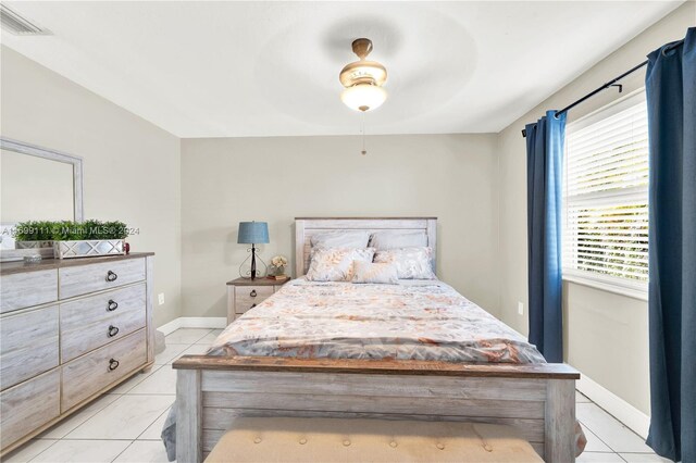 bedroom with ceiling fan and light tile patterned flooring