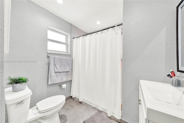 bathroom featuring tile patterned floors, vanity, and toilet