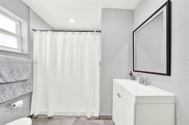 bathroom featuring toilet, vanity, and tile patterned floors