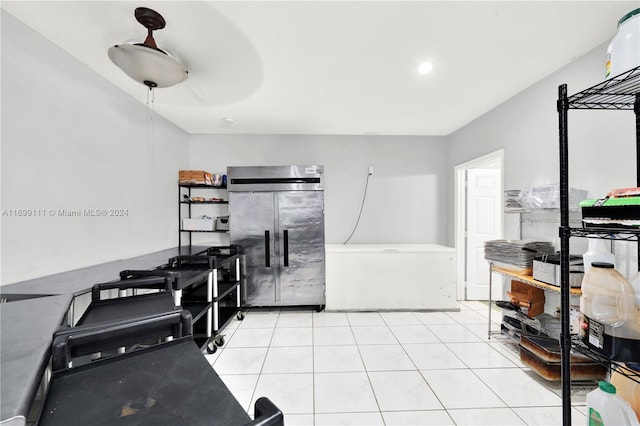 kitchen featuring stainless steel fridge, light tile patterned floors, and fridge