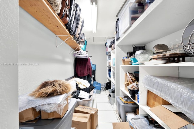 walk in closet with light tile patterned floors