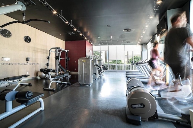 exercise room with floor to ceiling windows