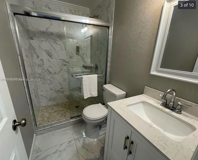 bathroom with walk in shower, vanity, and toilet