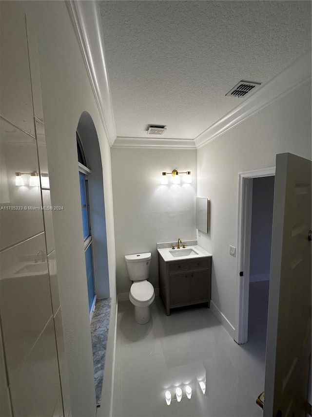 bathroom with vanity, crown molding, tile patterned flooring, toilet, and a textured ceiling