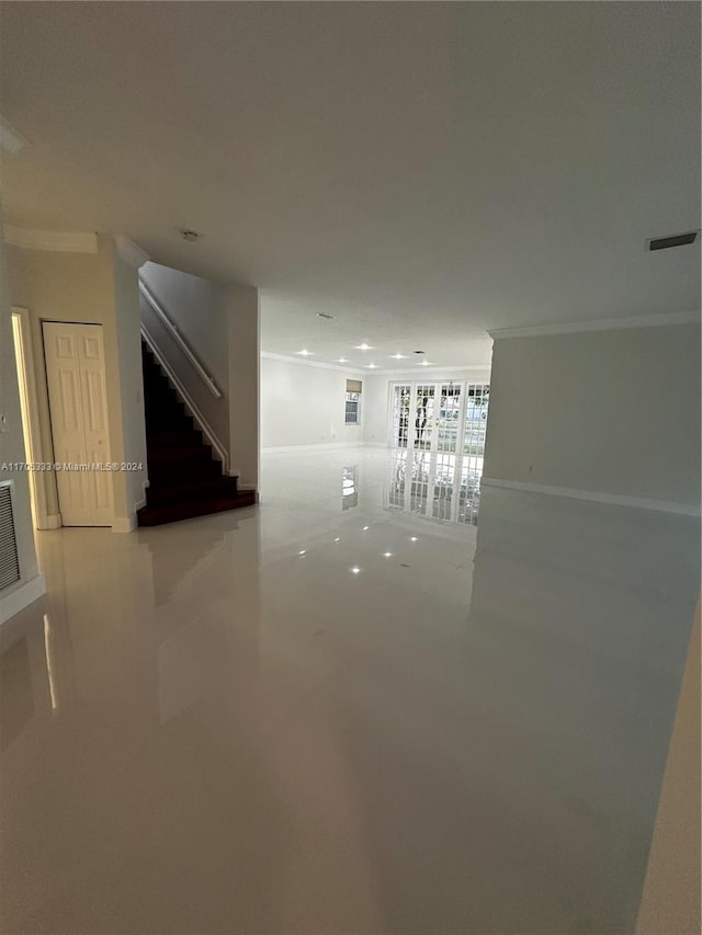 interior space with crown molding and concrete floors