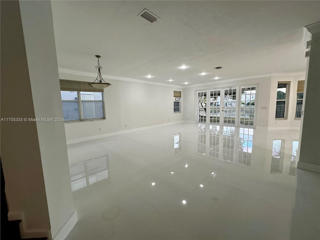 unfurnished room featuring tile patterned floors, a wealth of natural light, and ornamental molding