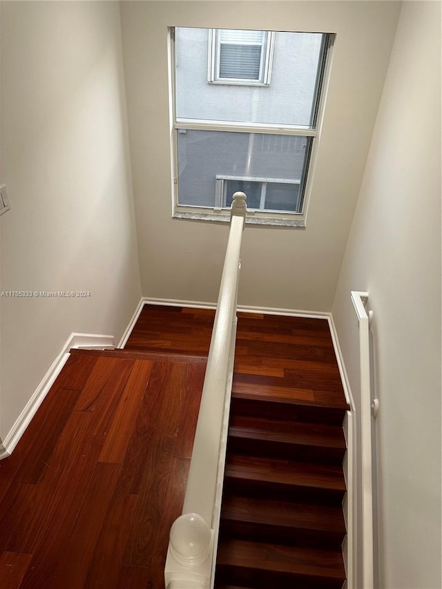 stairs featuring hardwood / wood-style flooring