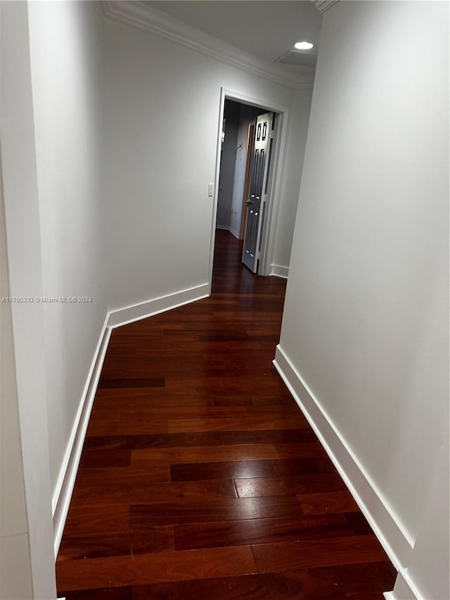 hall featuring crown molding and dark wood-type flooring