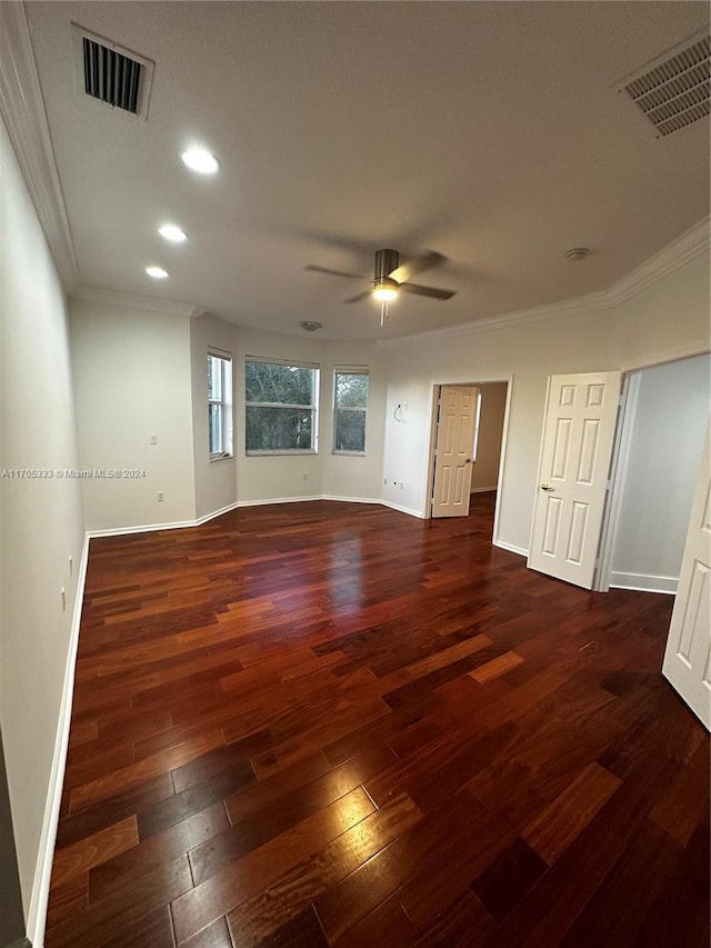 unfurnished room with ornamental molding, ceiling fan, and dark wood-type flooring