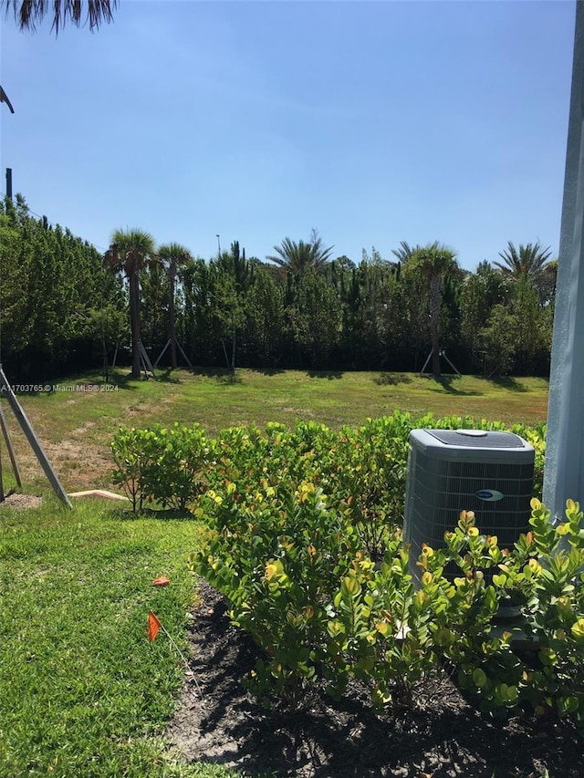 view of yard featuring central air condition unit