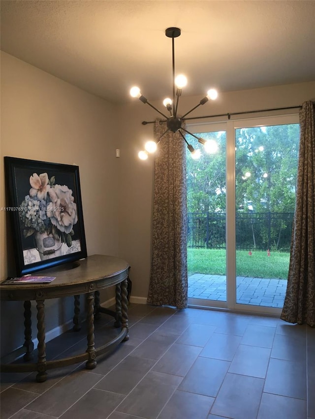 dining room featuring a chandelier and tile patterned floors