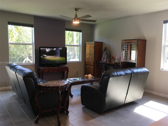 living room with a healthy amount of sunlight, ceiling fan, baseboards, and tile patterned floors