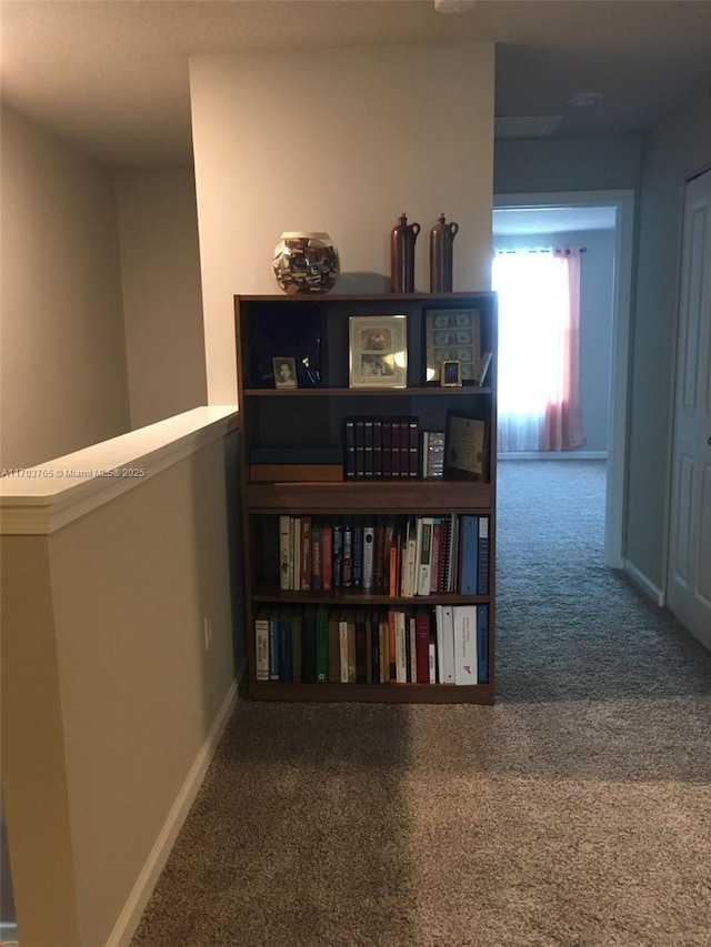 corridor with carpet floors and baseboards