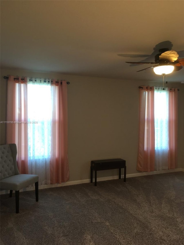 sitting room with carpet flooring, a wealth of natural light, and baseboards