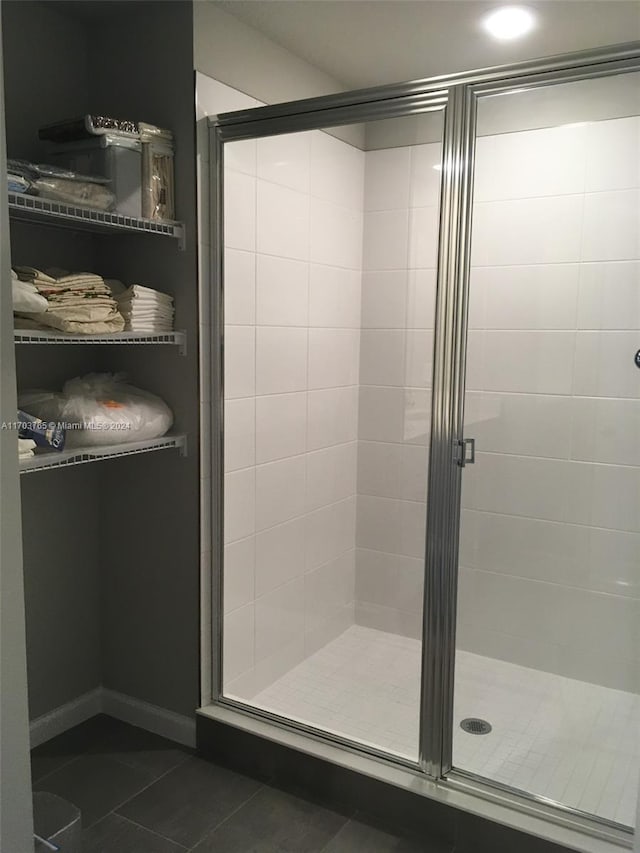 bathroom with tile patterned floors and an enclosed shower