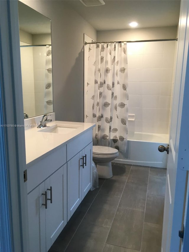 full bathroom featuring tile patterned floors, vanity, toilet, and shower / bath combo with shower curtain