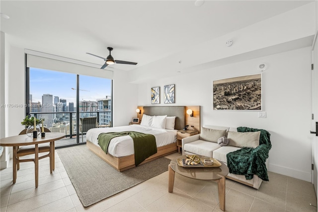 bedroom with access to exterior, ceiling fan, light tile patterned floors, and a wall of windows