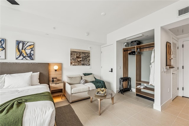 bedroom featuring a closet and light tile patterned flooring