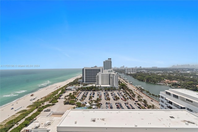 birds eye view of property featuring a water view and a beach view