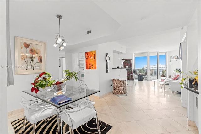 tiled dining area with floor to ceiling windows