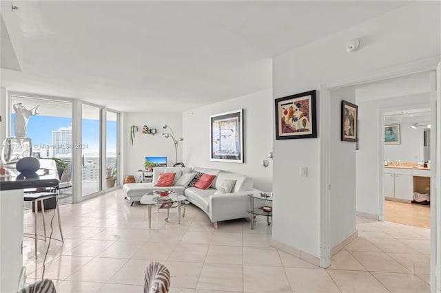 tiled living room featuring a wall of windows