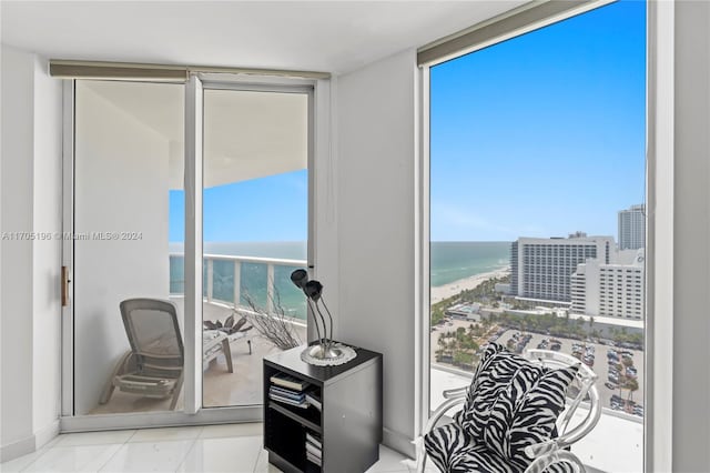 interior space featuring a water view and a beach view