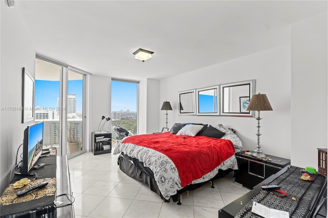 bedroom with light tile patterned flooring, floor to ceiling windows, and access to outside