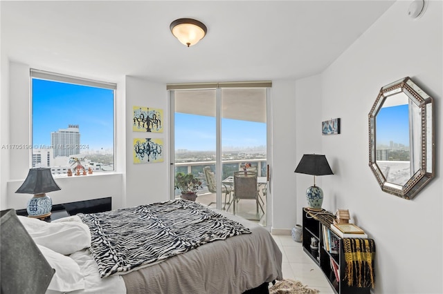 bedroom featuring access to exterior and light tile patterned floors