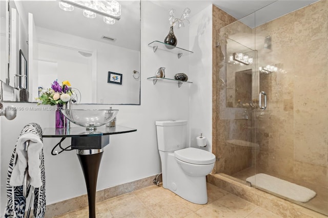 bathroom with tile patterned floors, toilet, and walk in shower