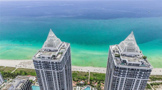 bird's eye view featuring a water view and a view of the beach