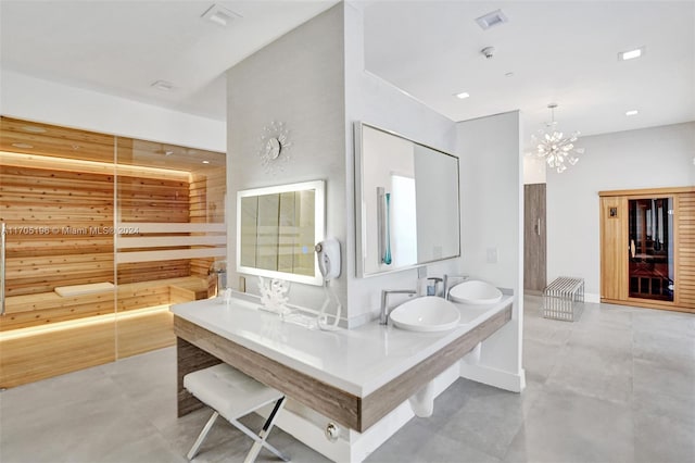 bathroom featuring a notable chandelier, vanity, and concrete floors