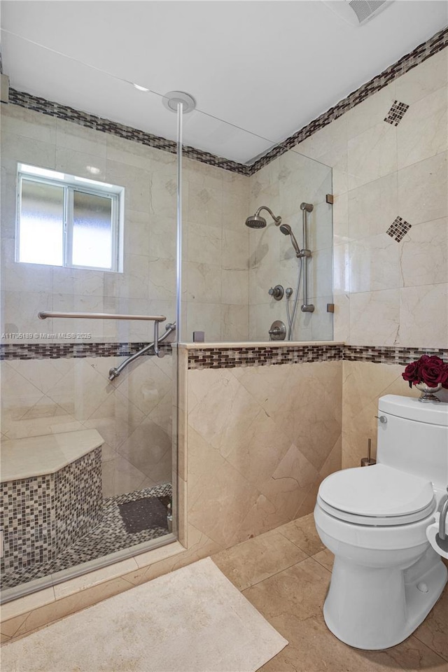 7720 SW 183rd Ter, Palmetto Bay, FL 33157 - bathroom featuring tile walls, tile patterned floors, toilet, and a tile shower
