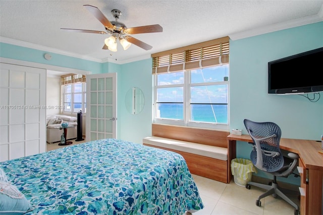 bedroom with crown molding, light tile patterned flooring, a textured ceiling, and ceiling fan