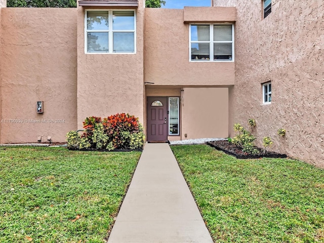 property entrance with a yard