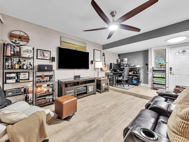 living room featuring hardwood / wood-style floors and ceiling fan