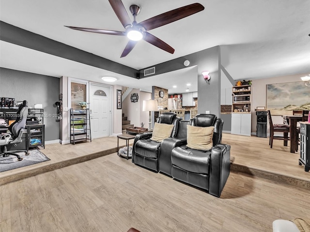 living room featuring light hardwood / wood-style floors and ceiling fan