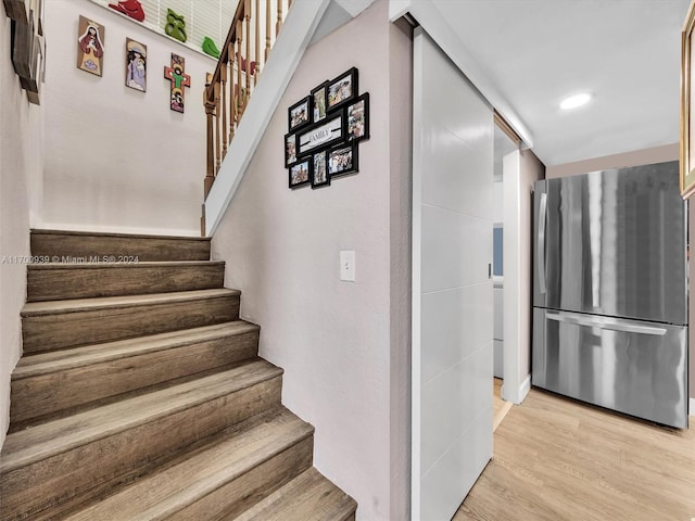 stairs featuring wood-type flooring