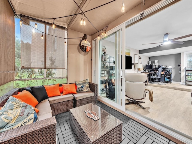 sunroom / solarium featuring a wealth of natural light and ceiling fan