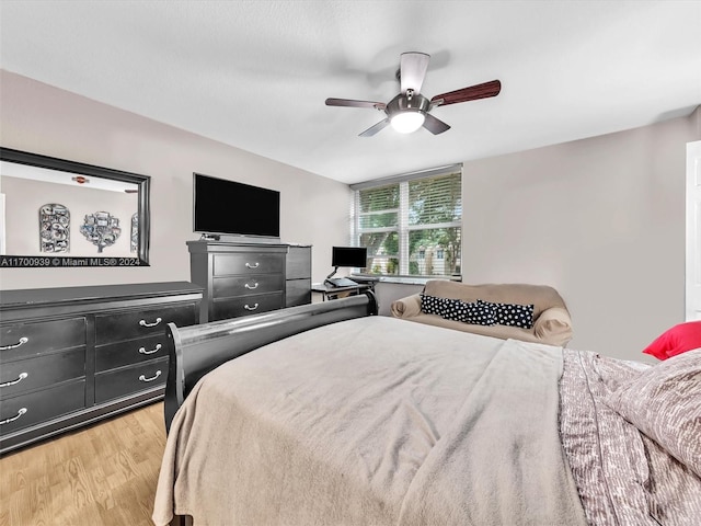 bedroom with ceiling fan and light hardwood / wood-style flooring